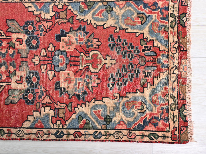a red rug with a blue and red design on it