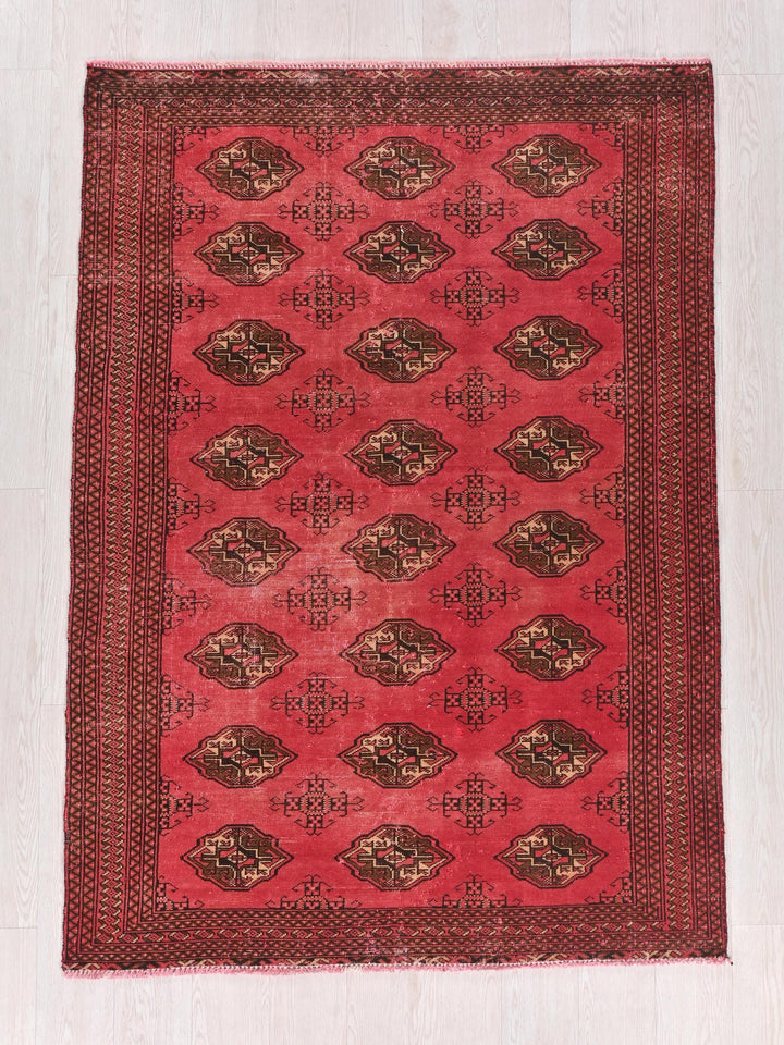 a red rug with a design on it