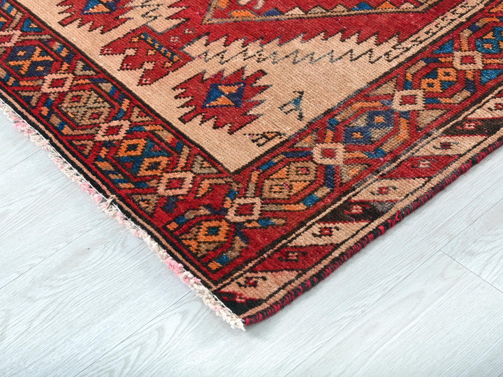 a red and blue rug on a white floor