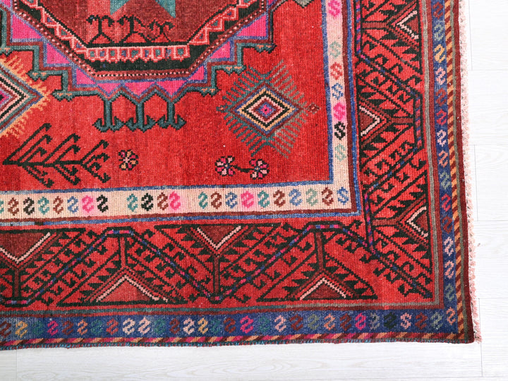 a red rug with a colorful design on it