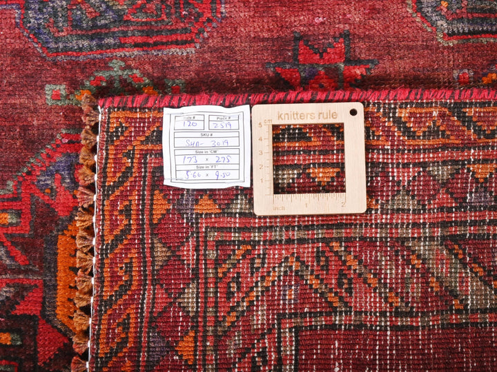 a red rug with a white square on it