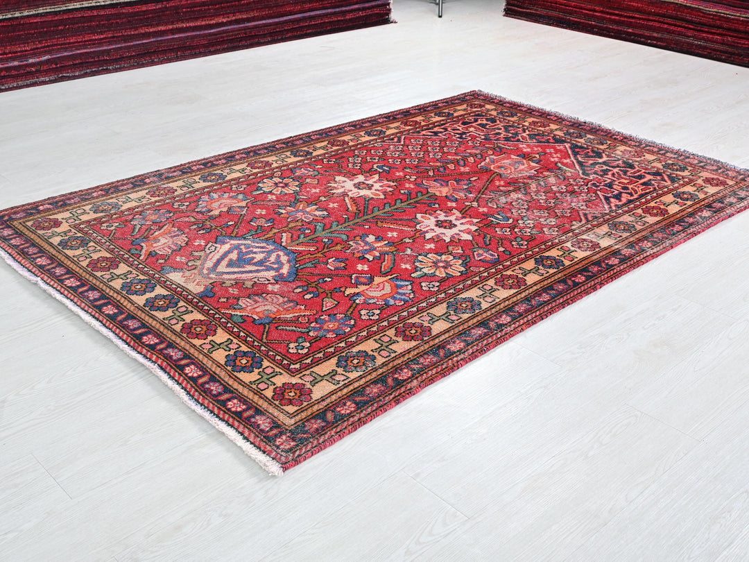 a red oriental rug on a white floor
