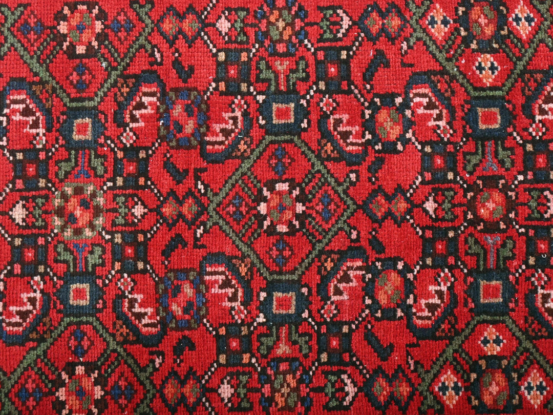 a close up of a red rug with a pattern on it