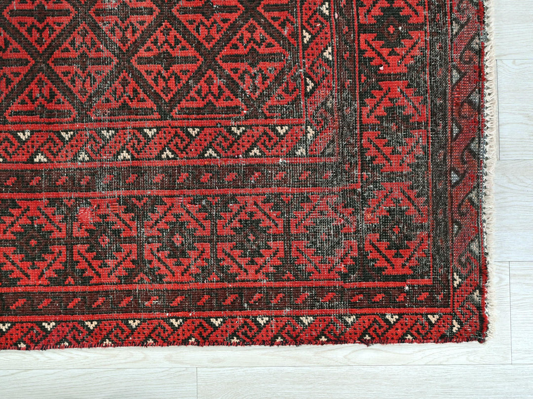 a close up of a red and black rug