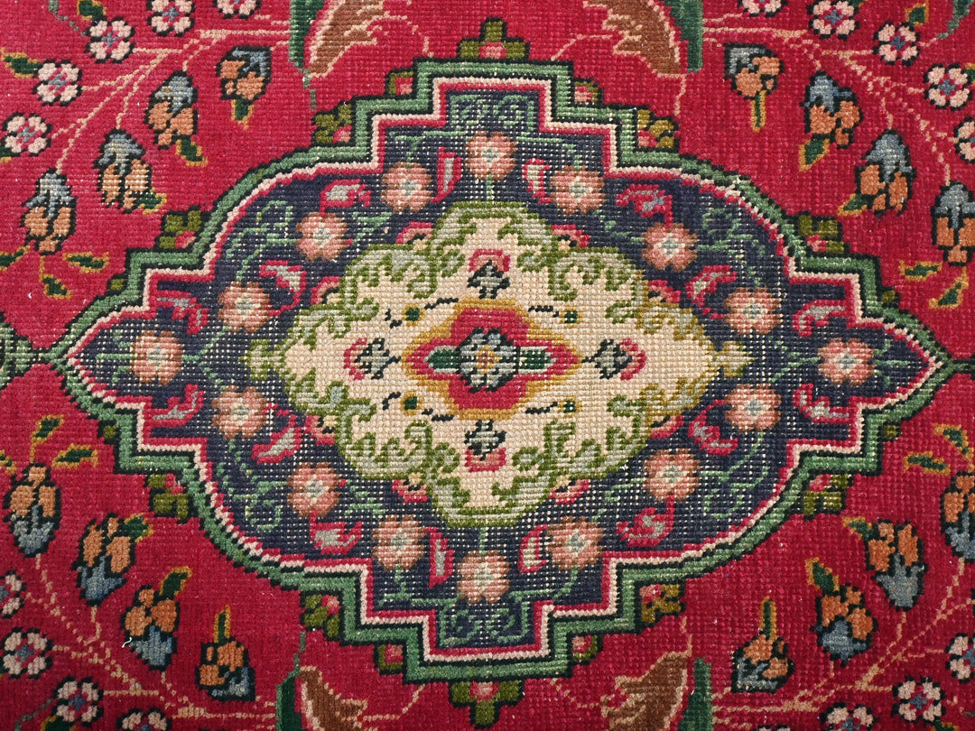 a close up of a rug with a red background
