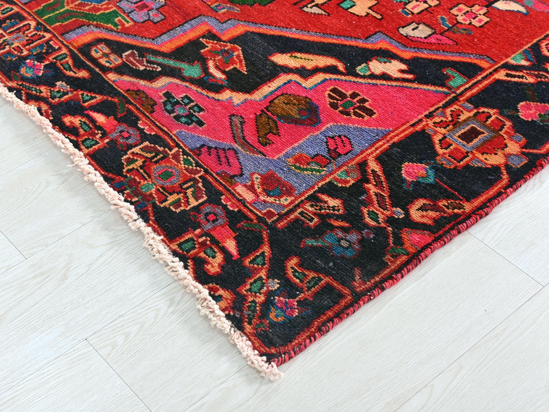 a colorful oriental rug on a white wooden floor