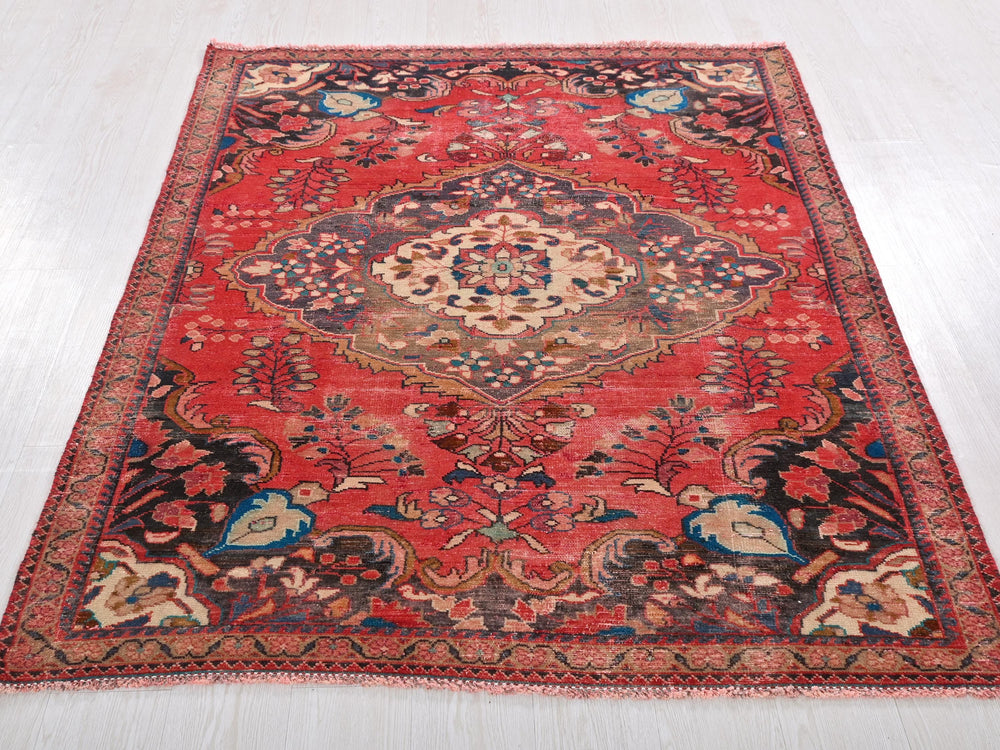 a red oriental rug on a white floor
