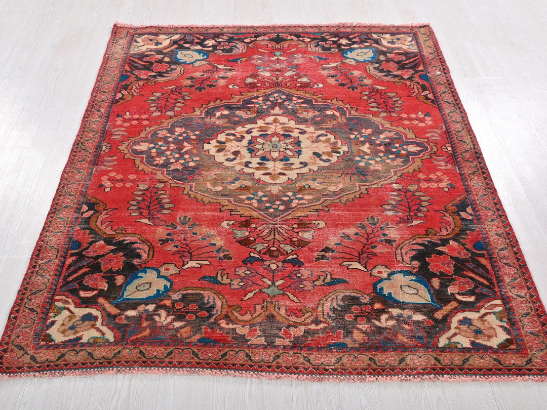 a red oriental rug on a white floor