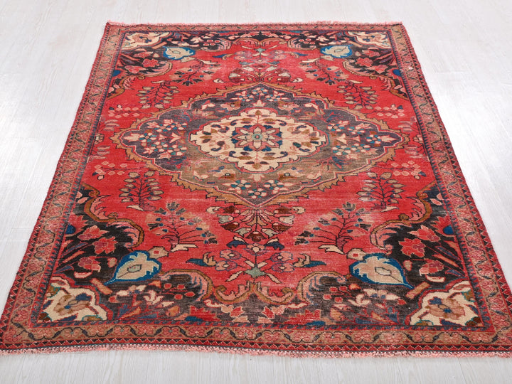 a red oriental rug on a white floor