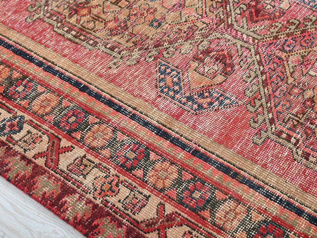 a close up of a rug with a wooden floor