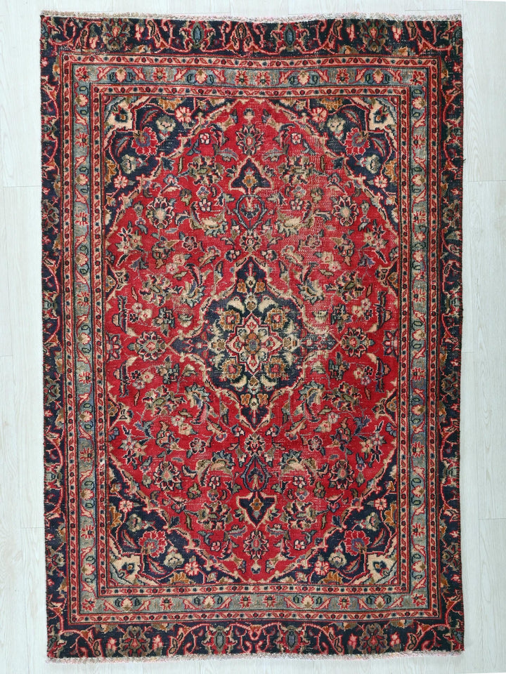 a red and blue rug on a white floor