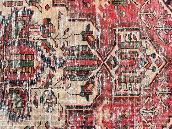 a red rug with a pattern on it