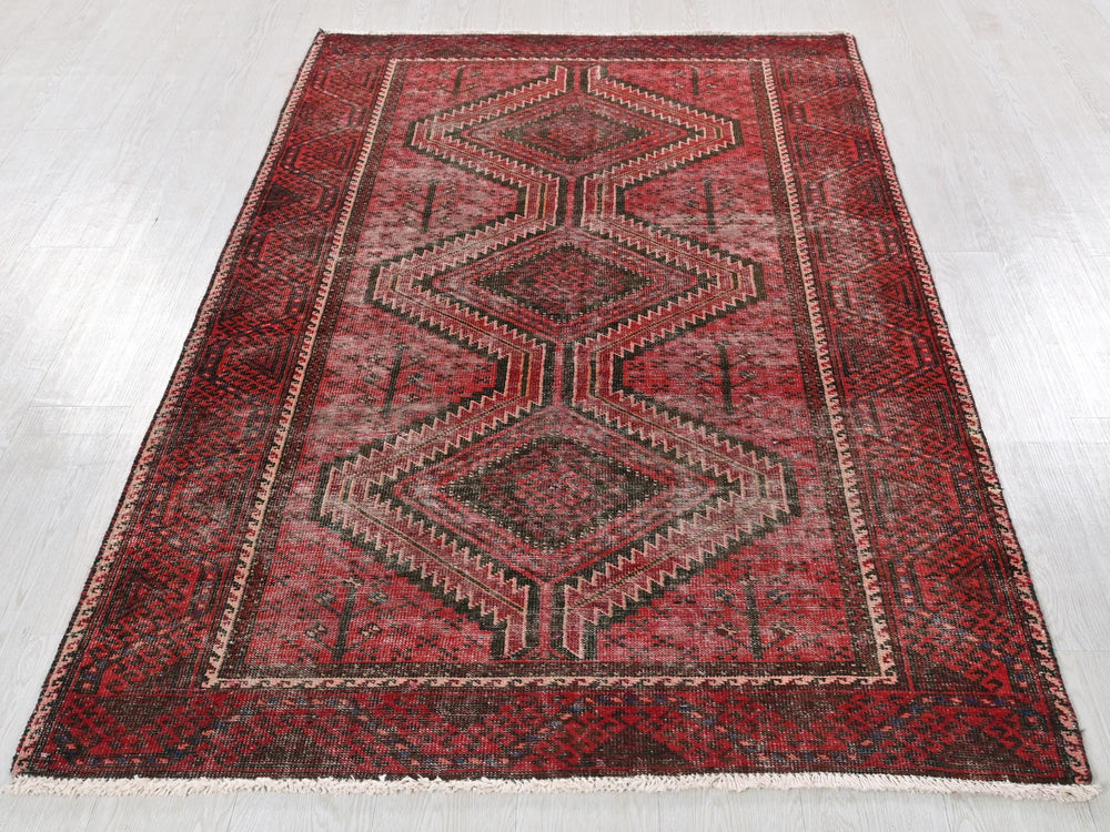 a red rug with a diamond pattern on it