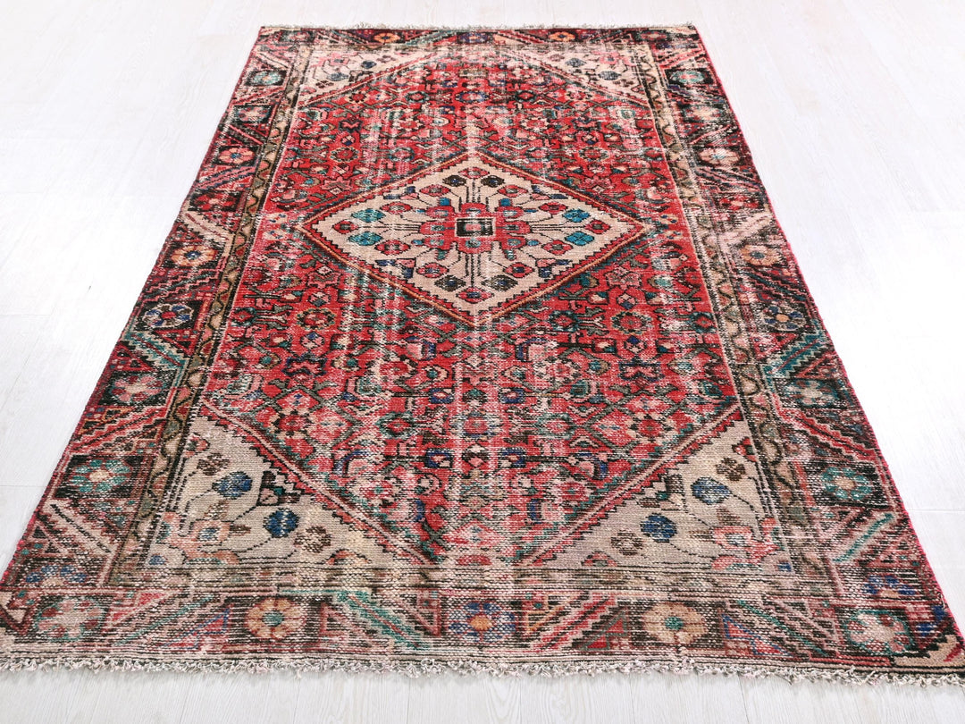a red rug with a diamond pattern on the middle of it