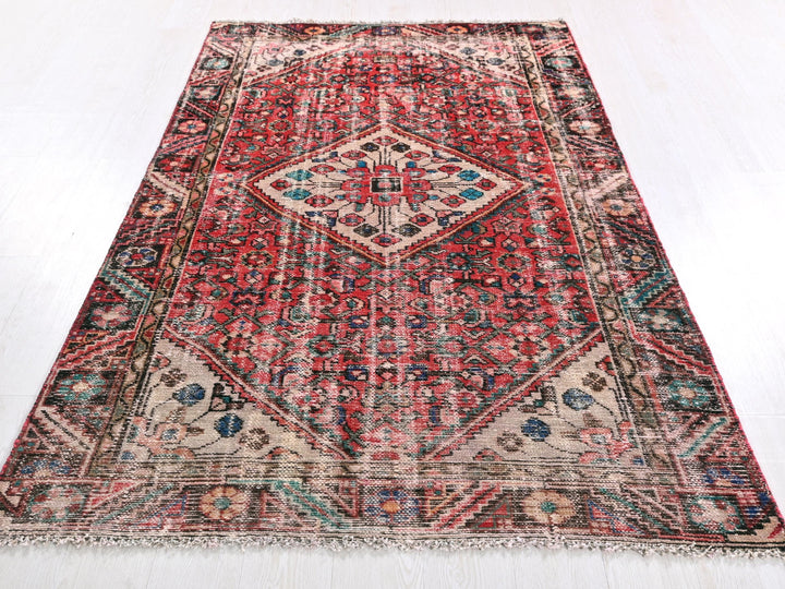 a red rug with a diamond pattern on the middle of it