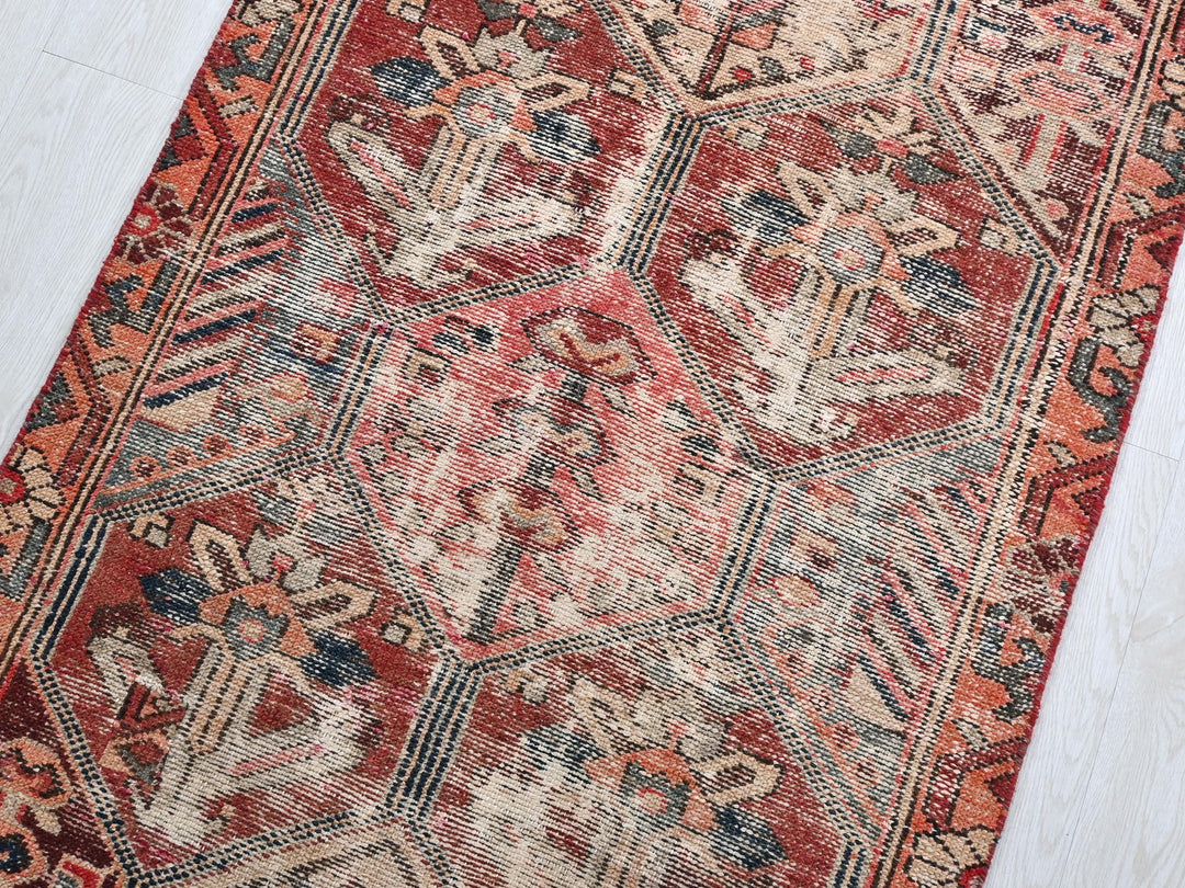 a red and blue rug on a white floor