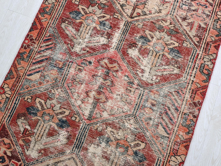 a red and blue rug on a white floor