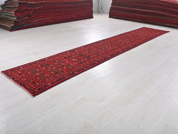 a pile of red rugs sitting on top of a white floor