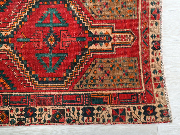 a red rug with a geometric design on it
