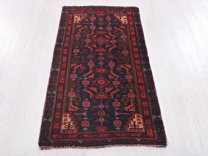a red and black rug on a white floor