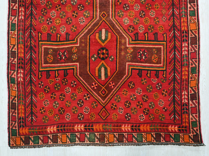 a red rug with a cross on it