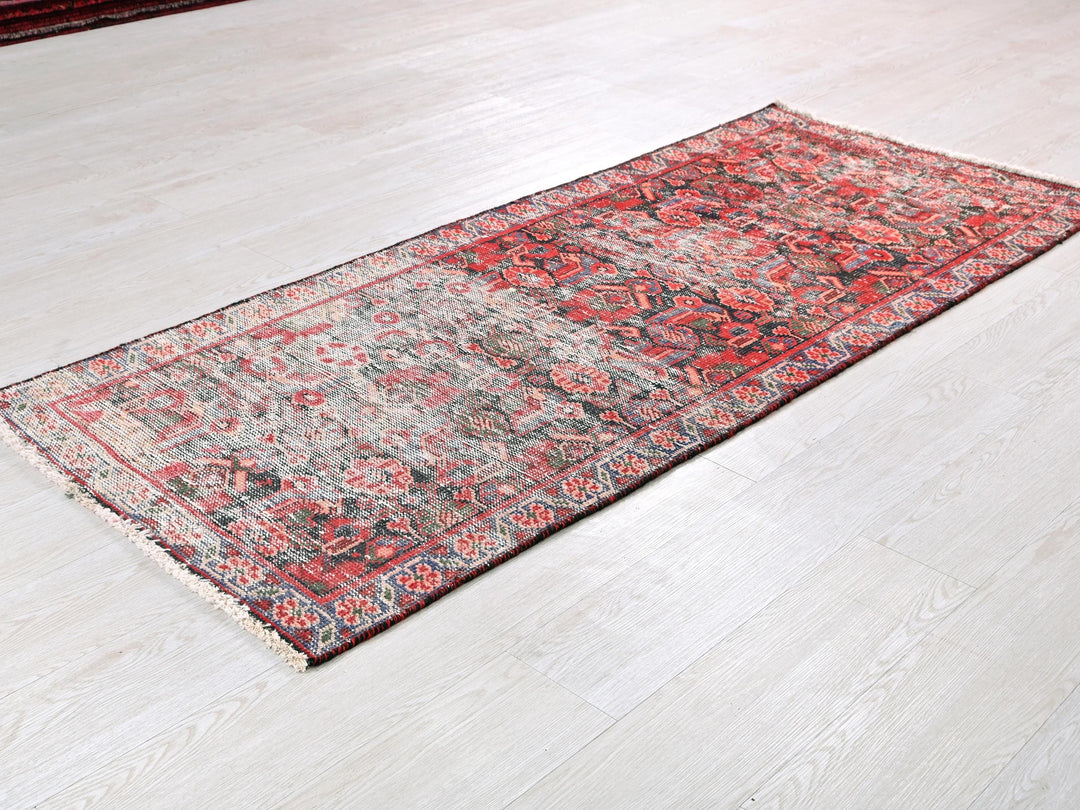 a red rug on the floor of a room