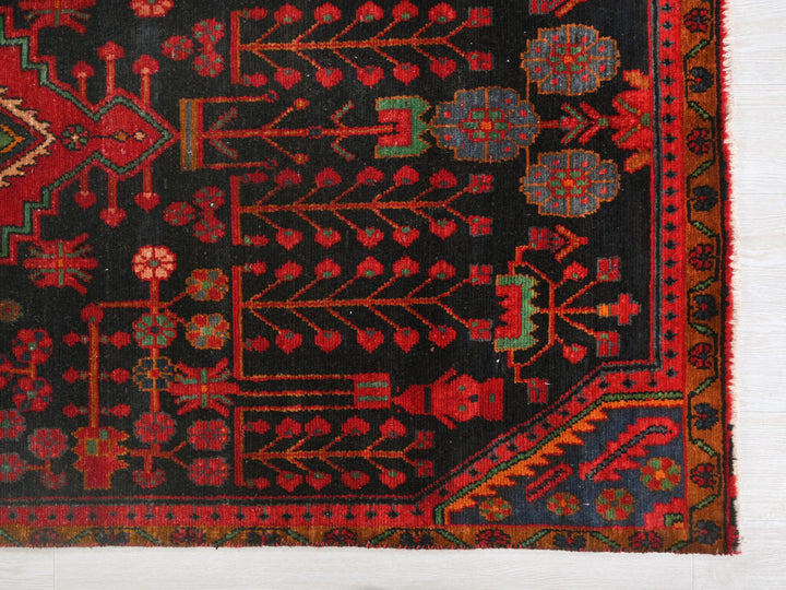 a red and black rug with a design on it