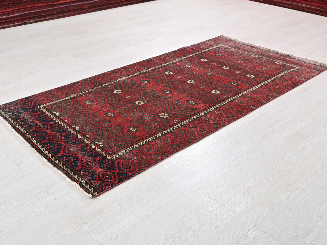 a red rug on the floor of a room