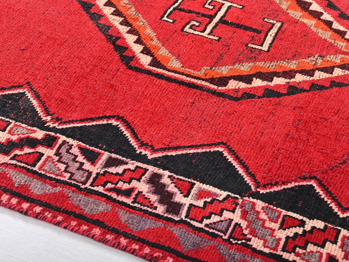 a close up of a red oriental rug