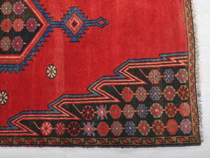 a red rug with a design on it