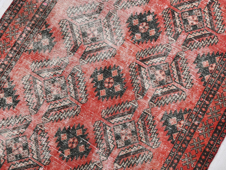 a close up of a red and black oriental rug
