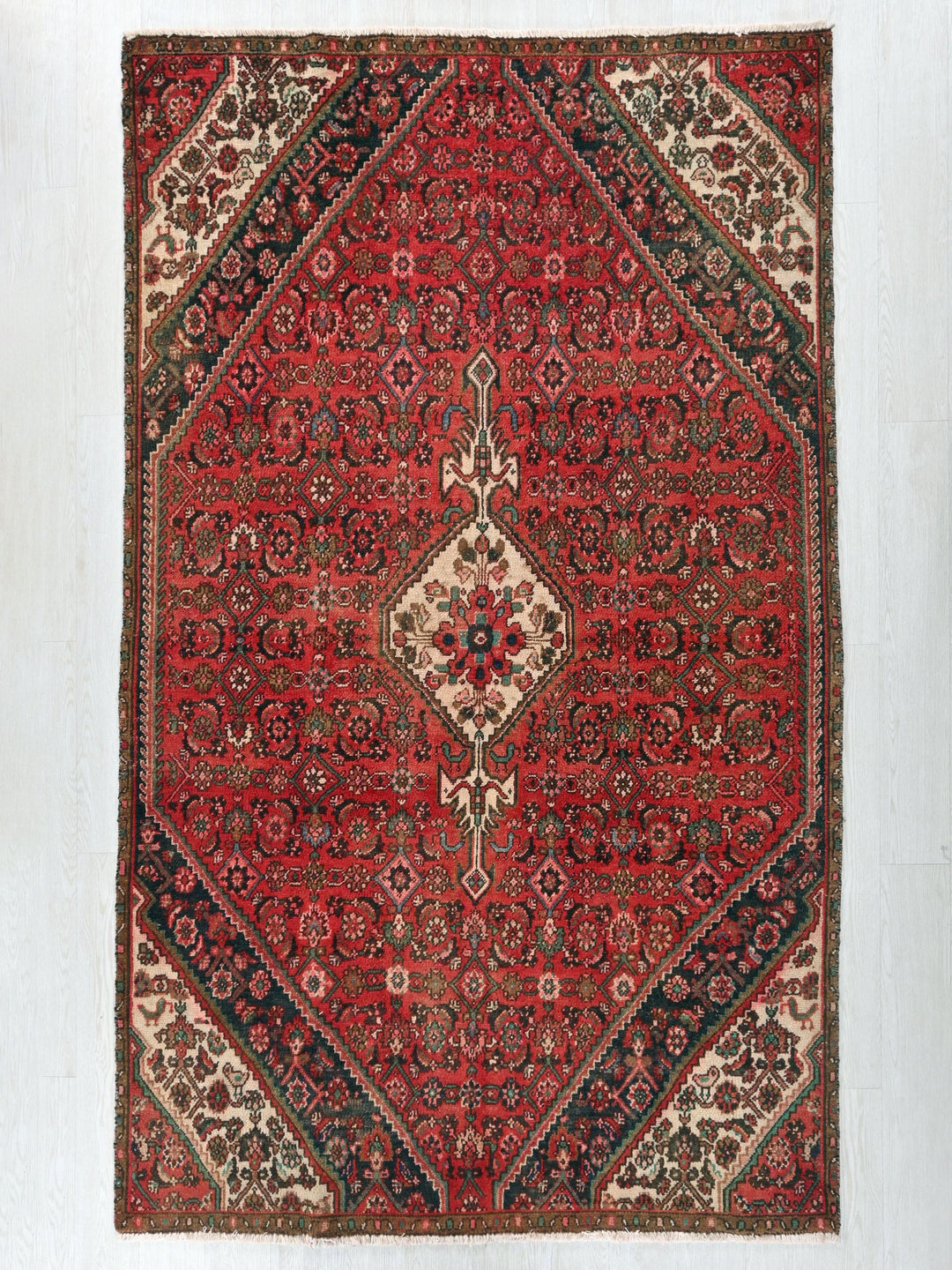 a red rug with a diamond shaped design