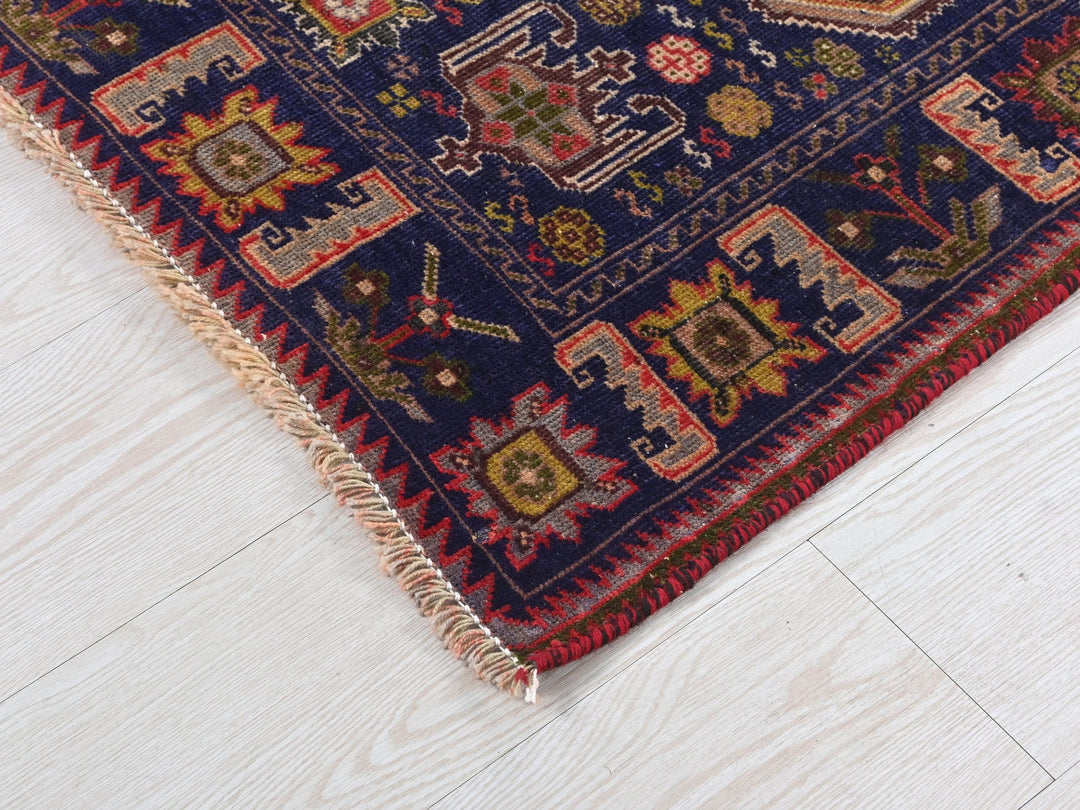 a blue rug on a white wooden floor