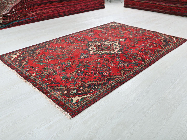 a red rug on the floor of a room