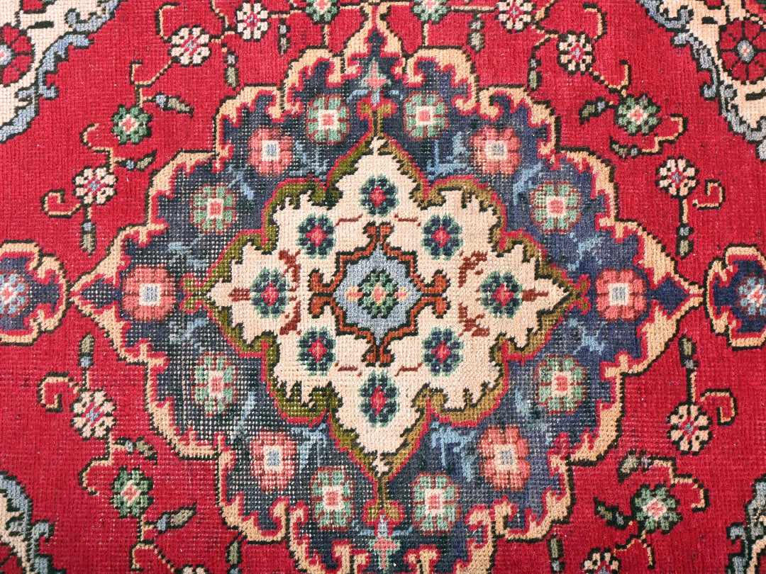a close up of a red oriental rug