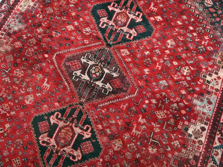 a close up of a red rug with a pattern on it