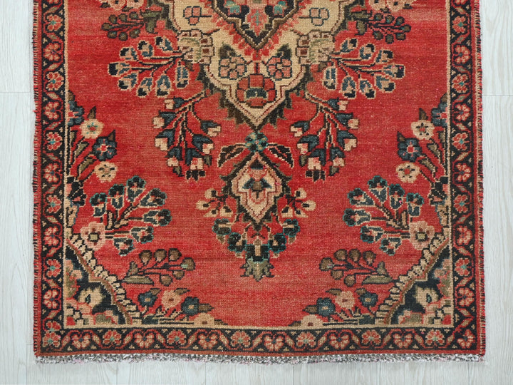 a red rug with a floral design on it