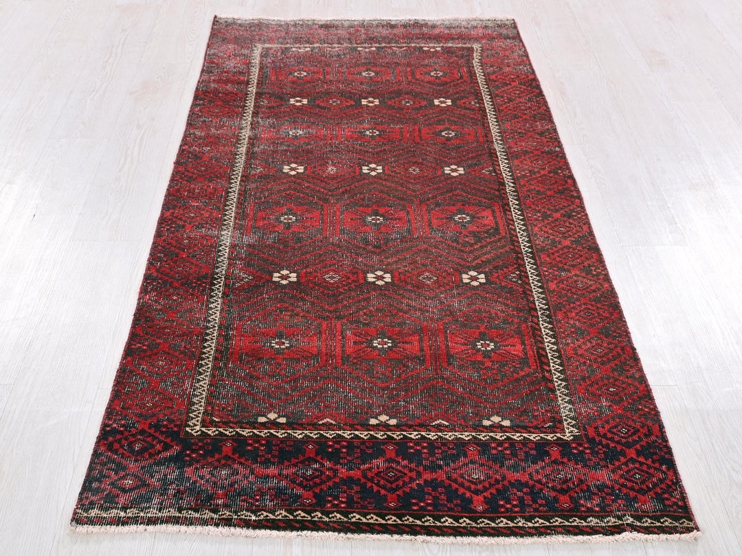 a red rug on a white floor in a room