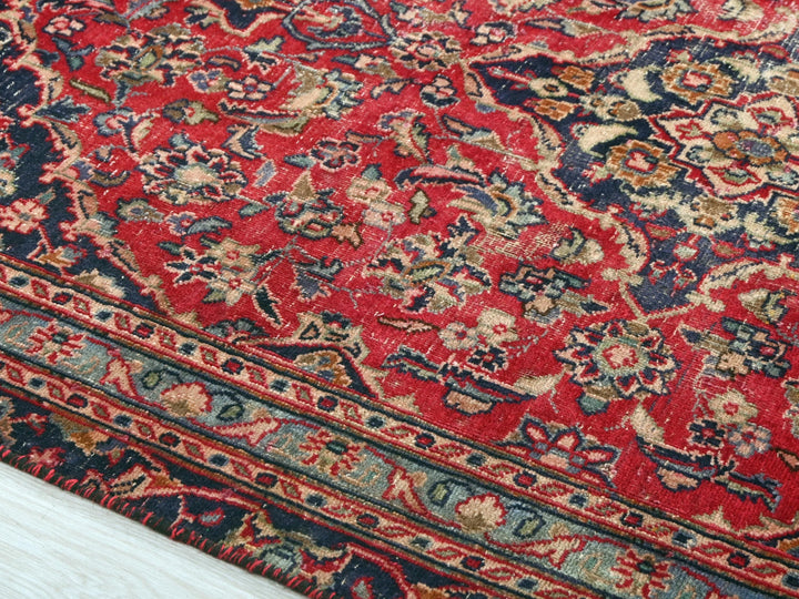 a red rug with a blue and gold design