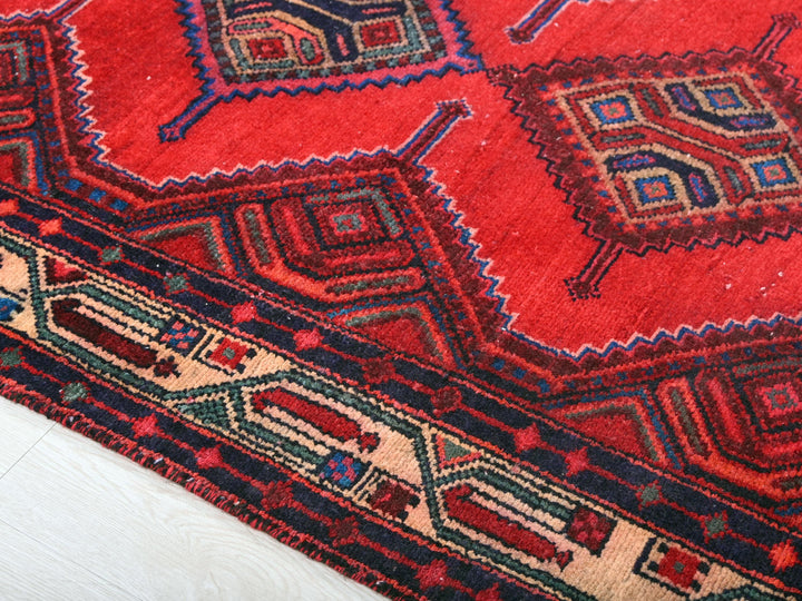 a close up of a red rug on the floor