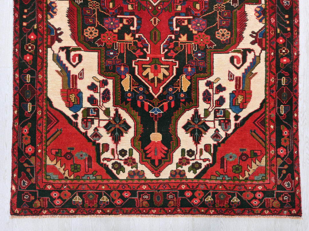 a red rug with a design on it