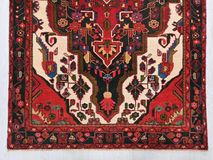 a red rug with a design on it