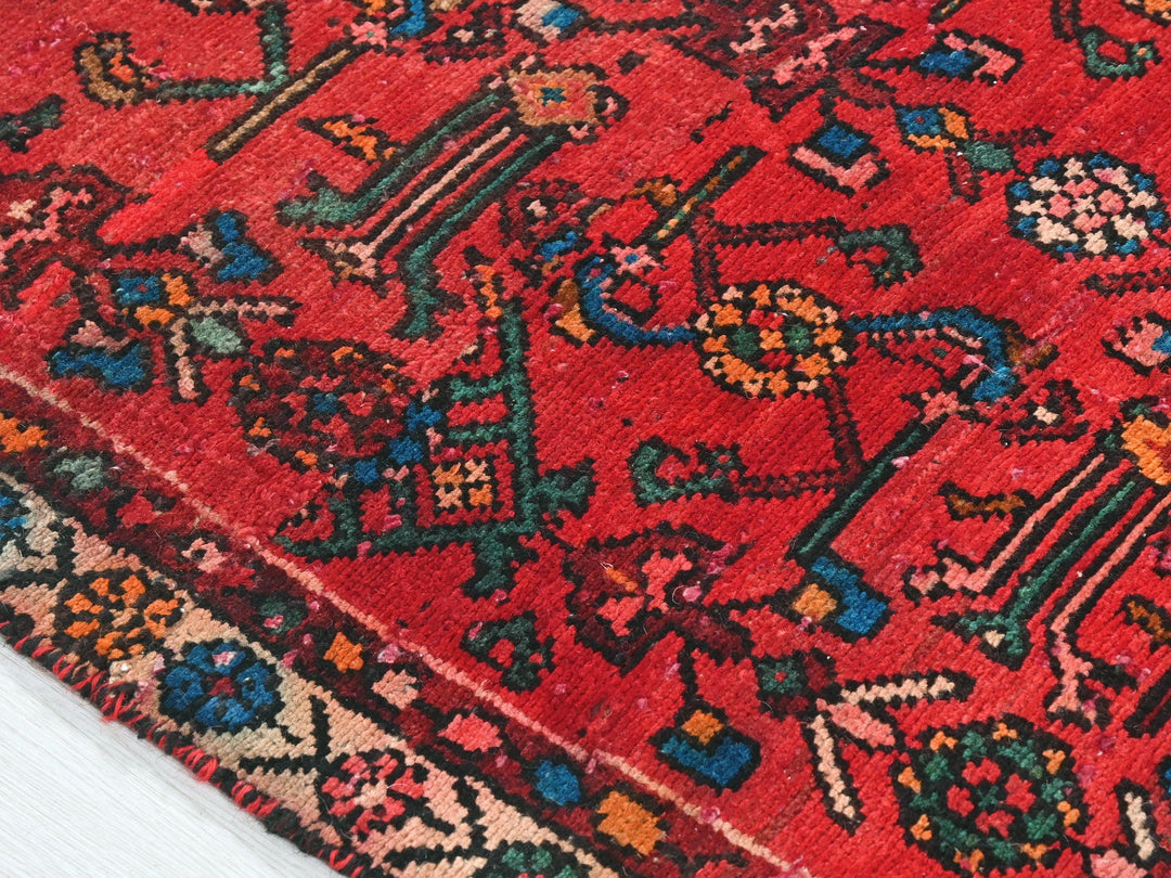 a red rug with a colorful design on it