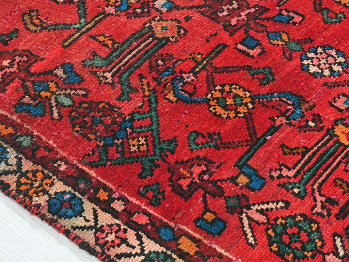 a red rug with a colorful design on it