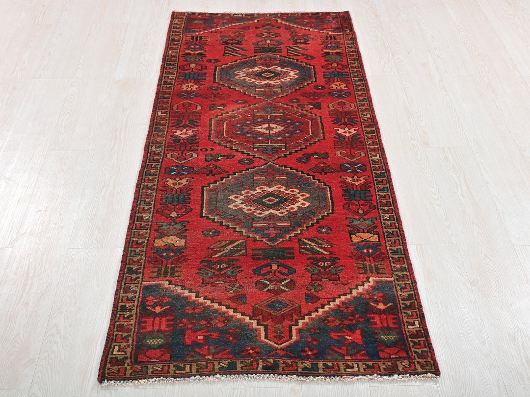 a red runner rug on a white floor
