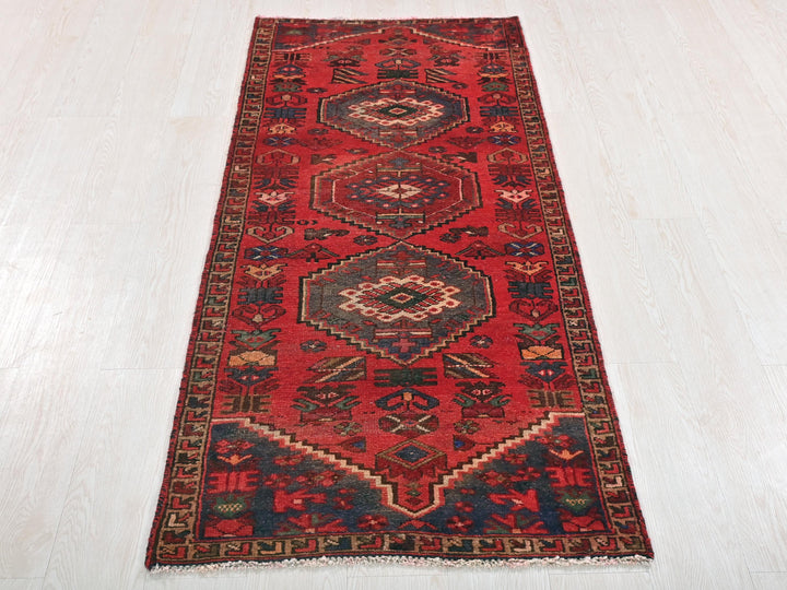a red runner rug on a white floor
