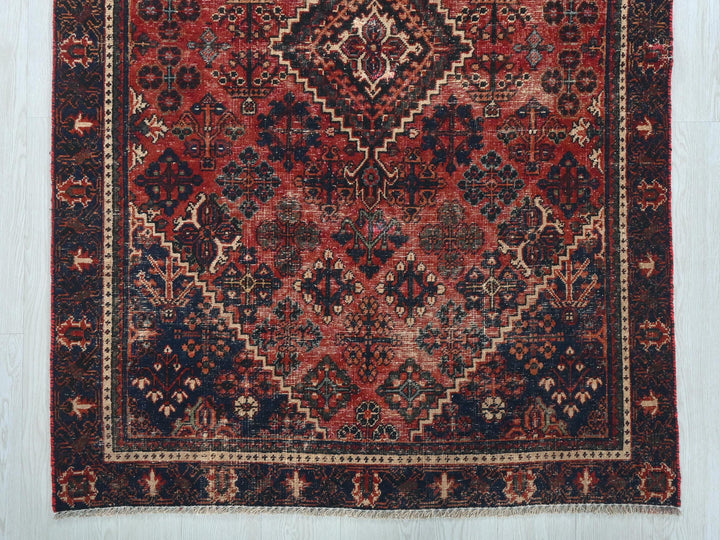 a red and black rug on a white floor