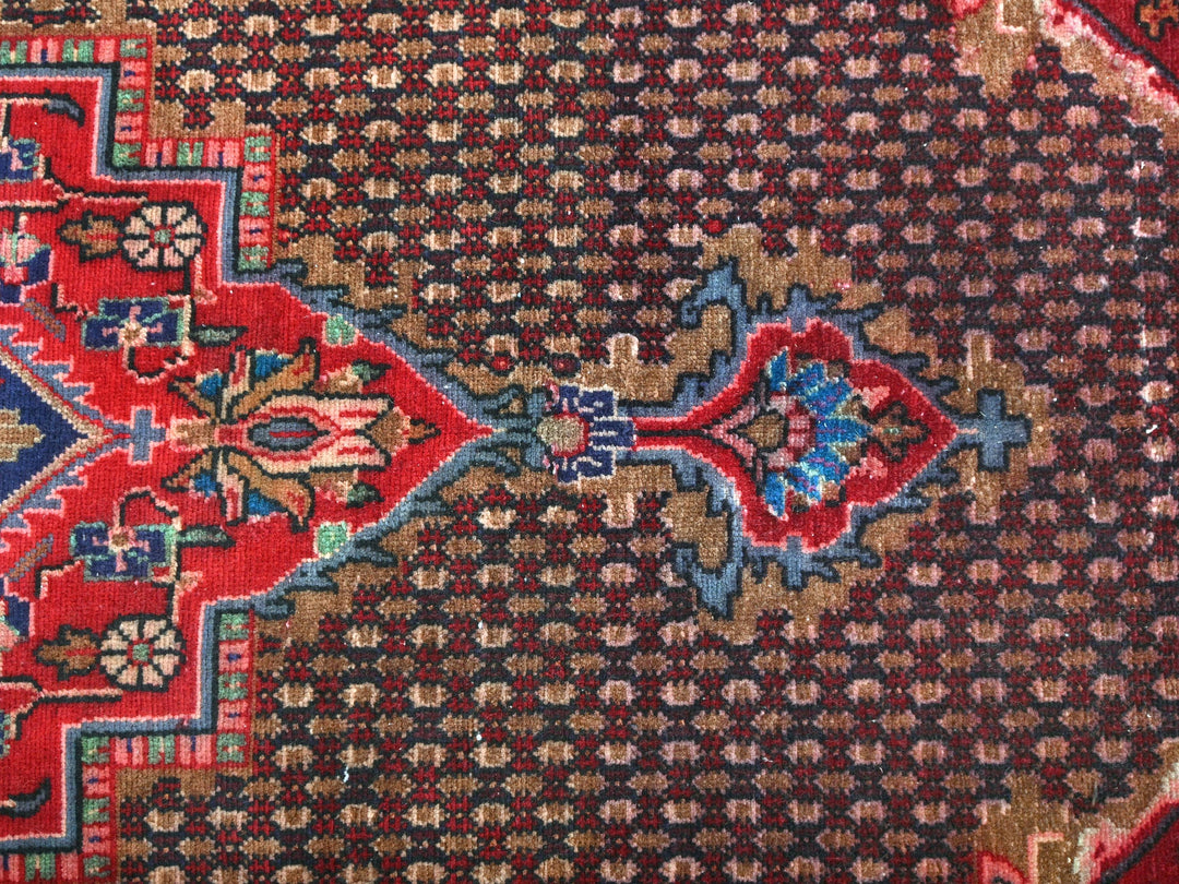 a close up of a rug with a red and blue design