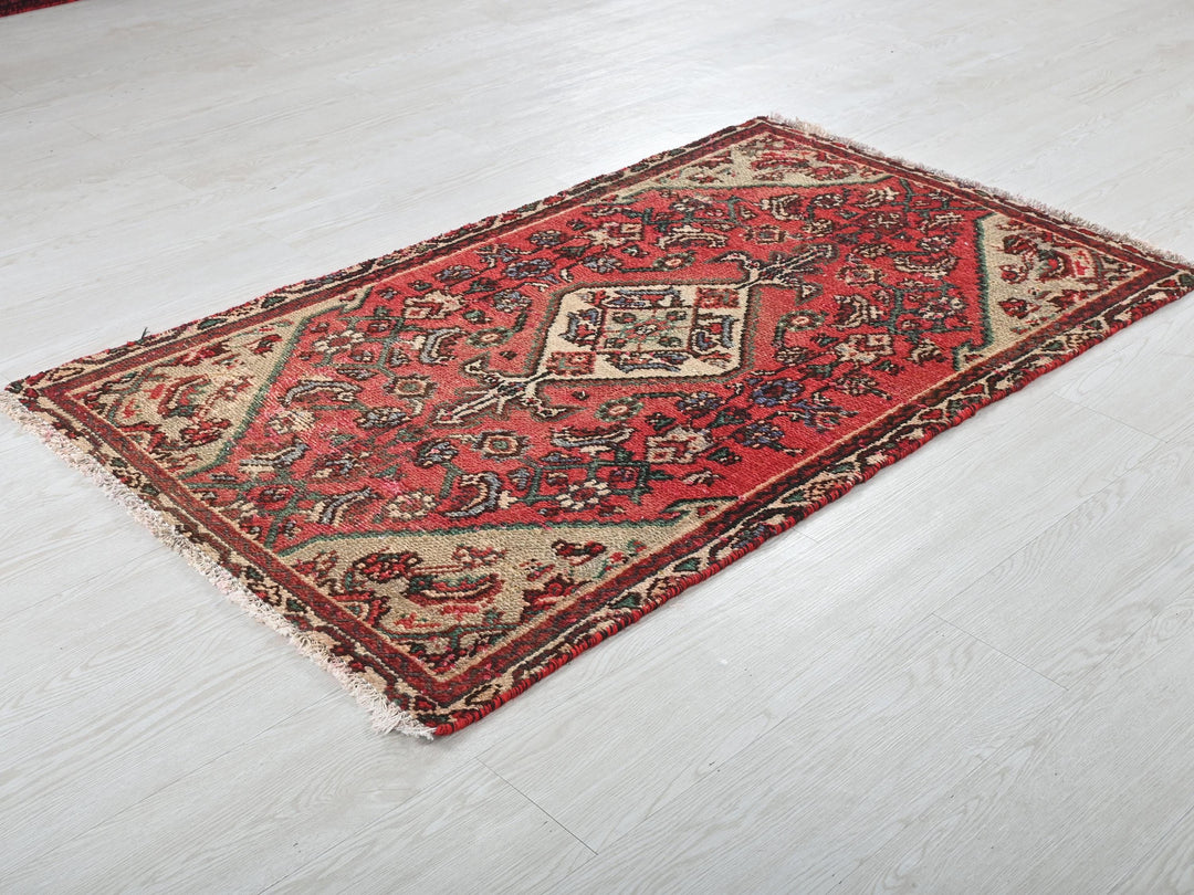 a red rug on the floor of a room