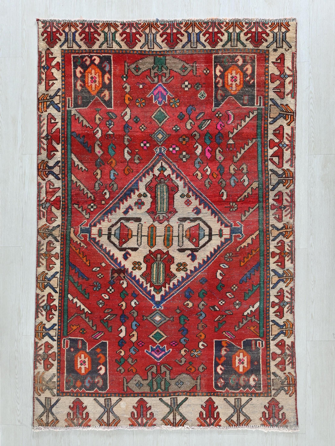 a red rug with a diamond shaped design
